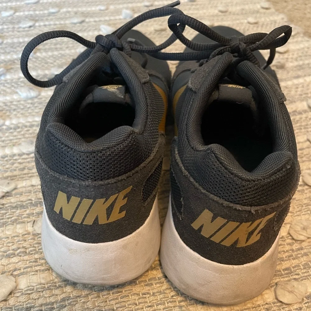 Nike Women’s 8.5 Black and Gold Sneakers